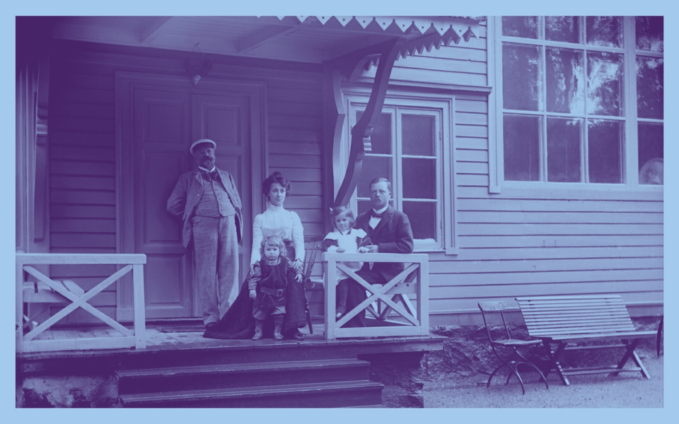 En familj på verandan till en villa. Foto.